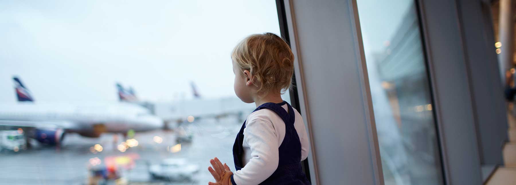 Baby looking at planes